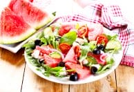 plate of watermelon salad on wooden table